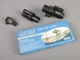 A Hawke Sport Optics Scope Mount Laser Kit along with another red dot scope.