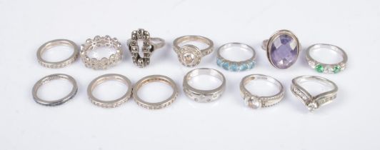 Thirteen silver rings to include eternity and paste set examples. Total weight 43.3g.
