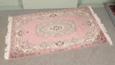 A large Chinese style rug. (260cm x 151cm)