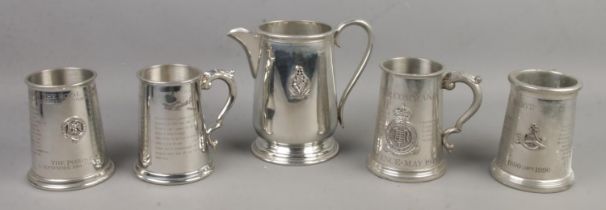 Four military themed pewter tankards along with a matching jug. Includes Royal Air Force Fighter