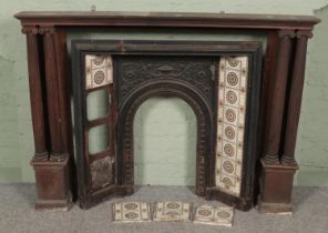 A cast iron fire place with carved oak mantel surround. (109cm x 151cm)