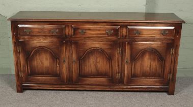 Hunter and Smallpage of York large oak sideboard featuring three drawers with three lower cupboard