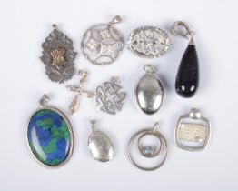 A collection of silver pendants and one brooch to include locket, Celtic knot and crucifix examples.