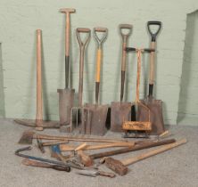 A collection of tools. Includes shovels, axes, pick, sledge hammers etc.