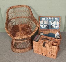 A wicker tub chair along with two wicker picnic sets include Optima example.