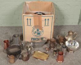 A large box of metalwares. Includes pedestal bowl, teapots, wine holder, tankards, etc.
