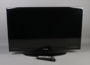 A Samsung 32 inch television with remote.