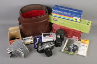 A collection of assorted camera equipment to include Canon AE-1 35mm film camera, Hoya 52mm Skylight