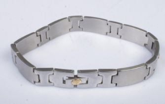 A stainless steel bracelet with 18k gold small studs.