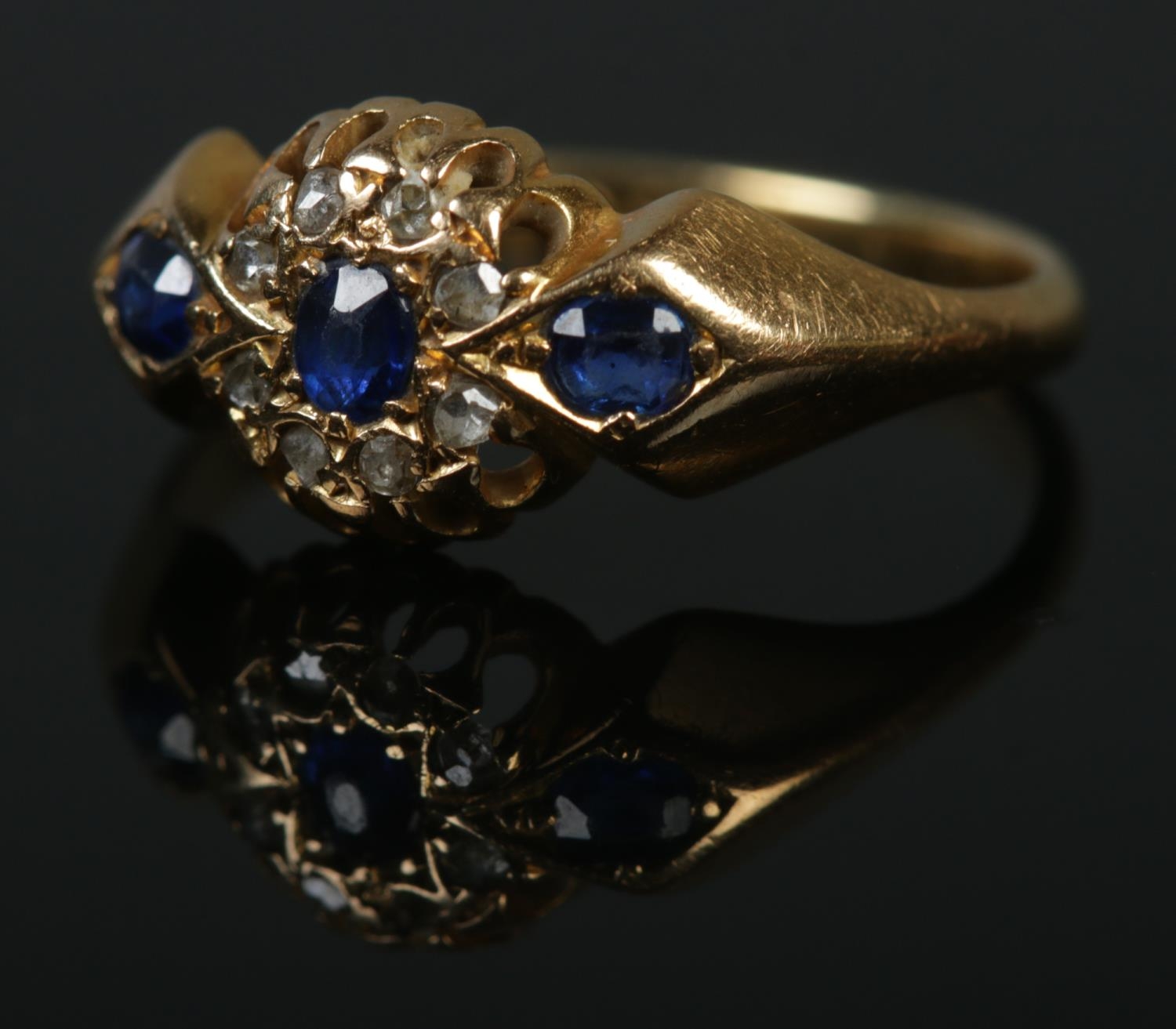 An 18ct Edwardian diamond and sapphire ring. Size L, 2.8g.