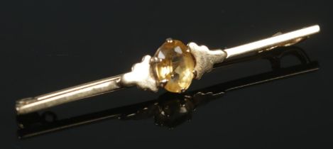 A 9ct gold bar brooch set with a citrine. 2.33g.