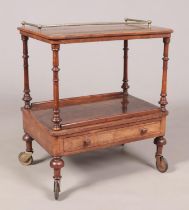 A Victorian walnut two tier side table. Having banded inlaid decoration, gallery top and single