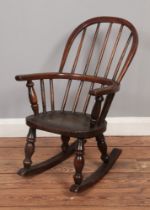 A Victorian child's spindle back Windsor rocking chair.