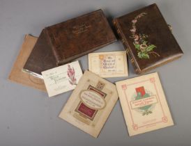 A collection of cigarette cards including two good quality empty albums one with leather and gilding