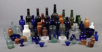 A large quantity of glass and stoneware vessels. Including coloured bottles, 'NOT TO BE TAKEN'