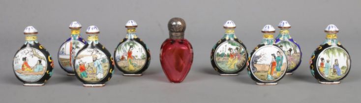 A collection of Chinese porcelain snuff bottles with scoops attached to the lids, together with a