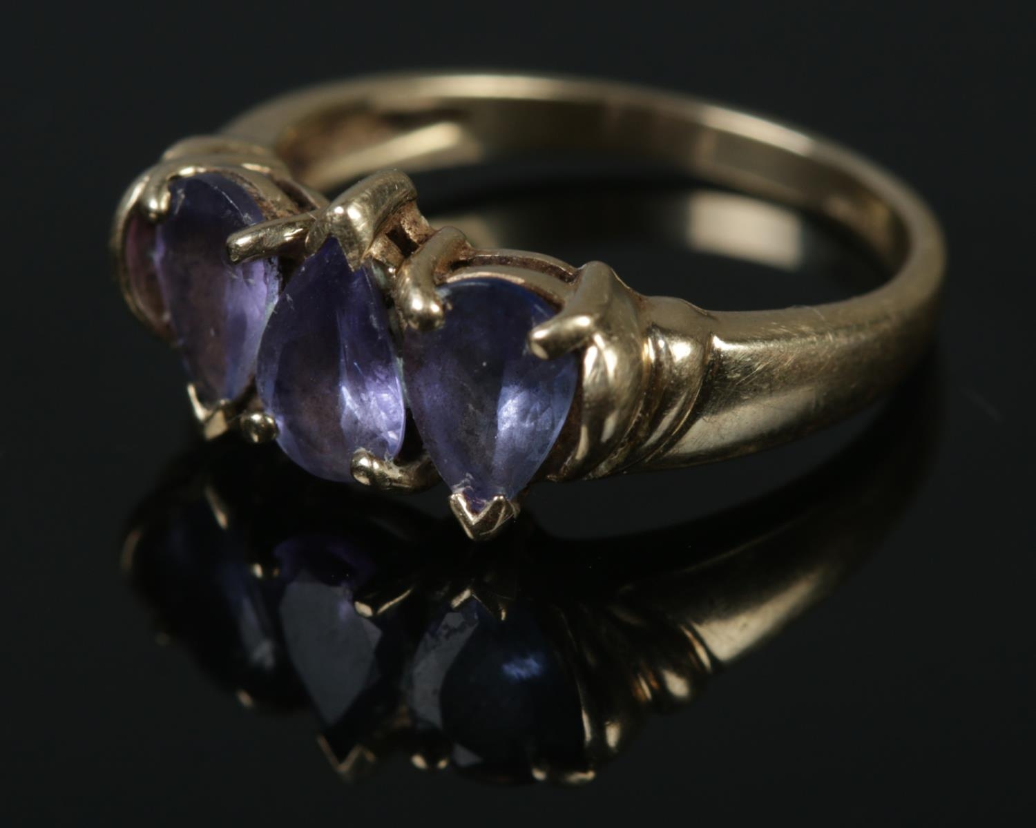 A 9ct gold three stone tanzanite ring. Size N, 3.05g.