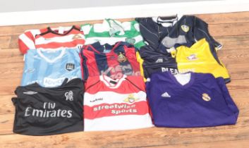 A collection of replica football shirts including Chelsea, Manchester City, Real Madrid, Leeds,