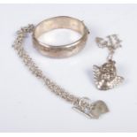 A collection of silver jewellery to include bangle, cherub pendant on chain and heart pendant on