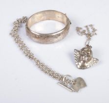 A collection of silver jewellery to include bangle, cherub pendant on chain and heart pendant on