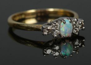 An 18ct gold, opal and diamond ring. Size N. 2.95g.