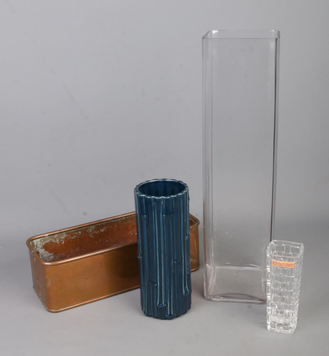 Three vases and a copper trough to include Holkham pottery and Nachtmann Bossa Nova examples.