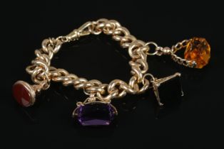 A 9ct gold curb link bracelet with four 9ct gold fobs set with Carnelian, Onyx, Citrine and Amethyst