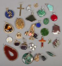 A quantity of pendants. Includes lapis lazuli, turquoise, silver mounted examples, etc.