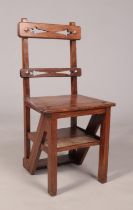 An Arts & Crafts oak metamorphic library step chair. Height of steps 88cm.