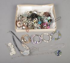 A tray of assorted costume jewellery of mainly necklaces and bracelets.