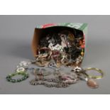 A tub of assorted costume jewellery to include necklaces, bracelets, bangles, etc.