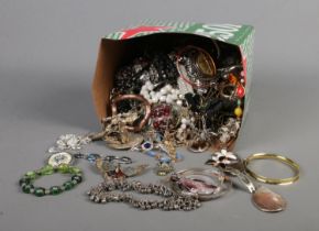 A tub of assorted costume jewellery to include necklaces, bracelets, bangles, etc.