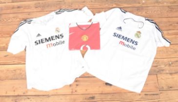 A pair of replica Real Madrid football shirts one with "Ronaldo 9" and the other "Beckham 23" to the