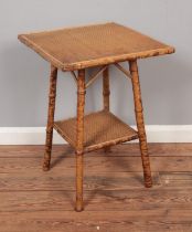 A Victorian Aesthetic movement bamboo table with rattan top.