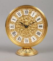 A mid 20th century gilt metal Jaeger alarm clock. Having scrollwork decoration, and Roman numeral