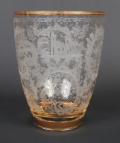 A Bohemian style glass vase with etched decoration depicting animals and having gilt banding. Height