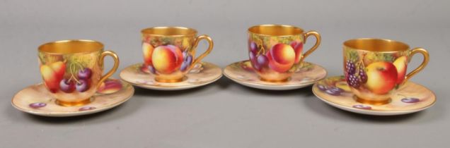 Four Royal Worcester porcelain coffee cups and saucers with hand painted decoration depicting fruit.