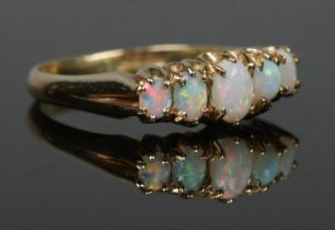 An 18ct gold five stone opal ring. Size Q. 4.29g.