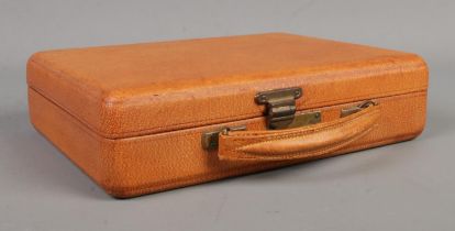 A vintage brown faux leather jewellery box by Asprey London. Height 6cm, Width 24cm, Depth 19cm.