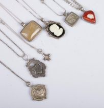 Seven silver pendants on chain. Includes golden rutilated quartz, football example, etc. 100g