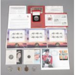 An assortment of coins and stamps, to include Platinum Jubilee, Millennium and '150th anniversary of