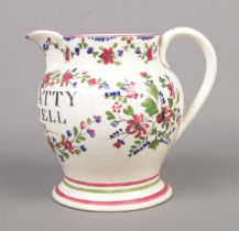 A 19th century creamware jug with hand painted decoration and bearing the name James Batty,