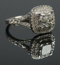 A 14ct white gold diamond cluster ring. The four central square cut diamonds with double halo