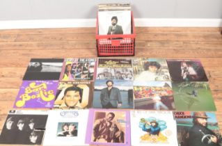 A box of LP records. Includes Beatles, Rolling Stones, U2, Madness, David Essex, etc.