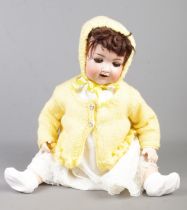 An Armand Marseille bisque head doll stamped A.12 M to reverse.