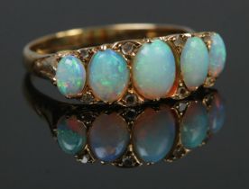 A gold and five stone opal ring. Tests as high carat. Size L. 3.44g.