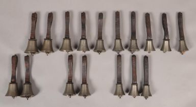 Seventeen small early 20th century campanology hand bells with leather straps with maker's marks for