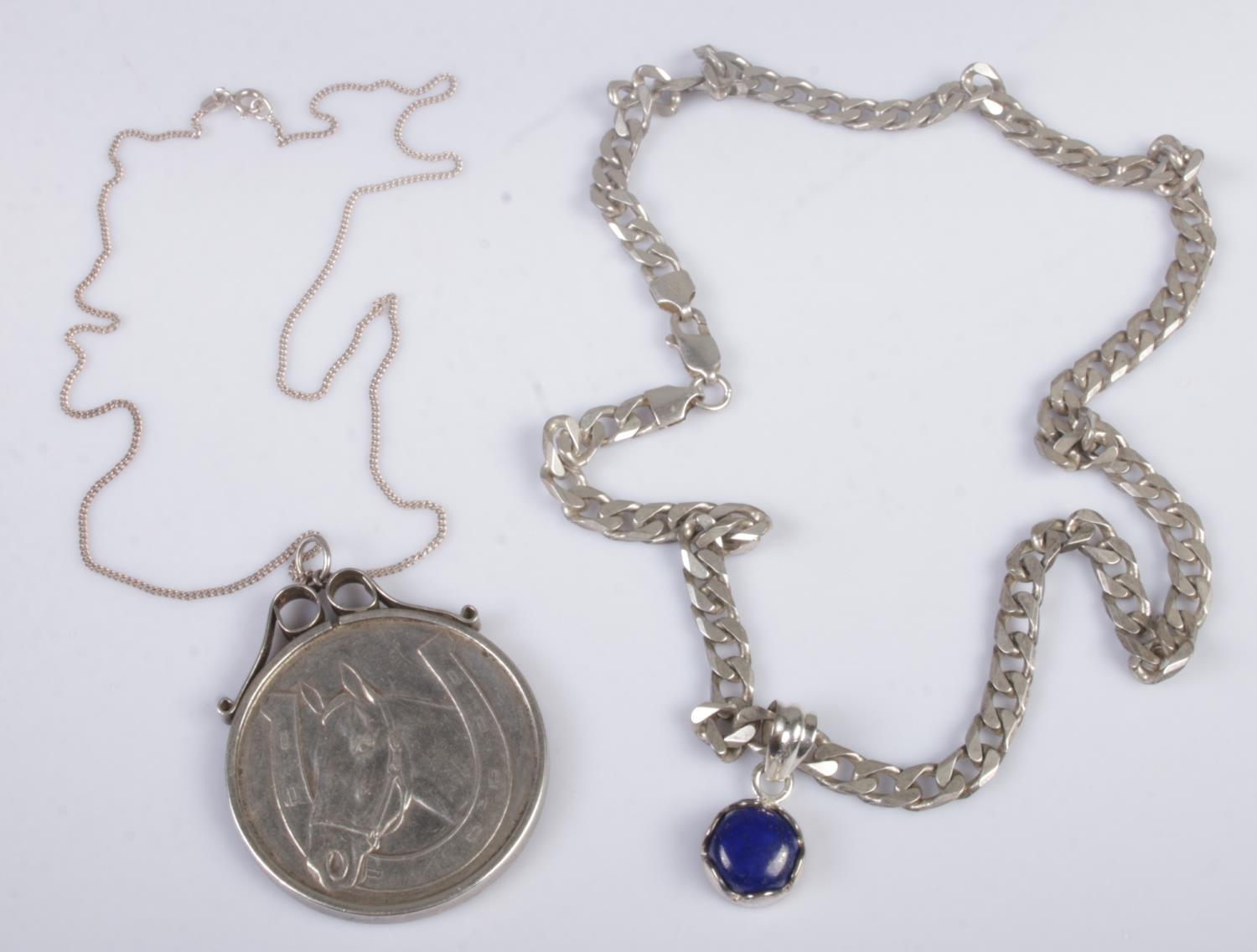 Two silver chains and pendants. Includes a silver .999 good luck coin, etc. 73g.