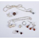 A collection of silver jewellery to include necklaces, Adam and Eve apple charm, earrings, etc.