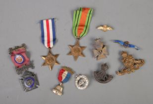 A collection of mostly military medals and badges including The France and Germany Star, Kings Royal